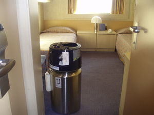 Photo of a cruise ship cabin where a liquid O2 reservoir has been installed. The patient staying in this cabin can do nocturnal oxygen therapy directly from the reservoir and ambulation therapy by re-filling a pack from the reservoir.