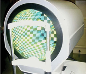 The VU Topographer, as seen from the subject's perspective: the head and chin rest for patient fixation and the topographer casing holding the color-coded stimulator pattern of squares.