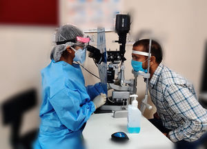 Modification of the slit lamp biomicrosopy technique by placing used x-ray film to separate the viewing arm from the patient’s end.