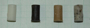 Cement test tubes for compression trials (from left to right: control cement, with rifampicin, with PHBV microcapsules and with alginate microcapsules).
